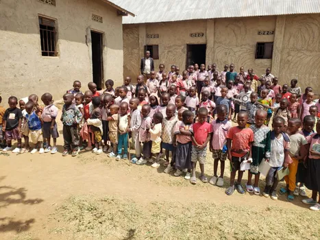 A large group of students gathered outside their school