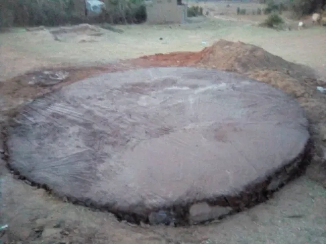A circular concrete base covered with sheeting at the construction site